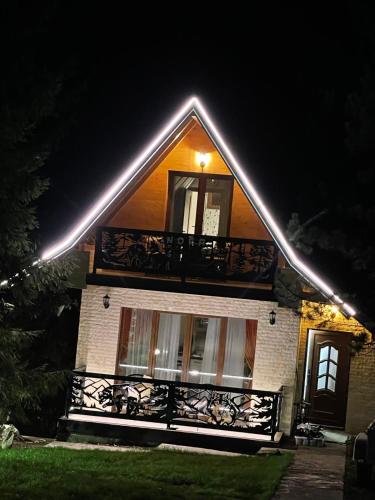 a house with a balcony with lights on it at Brvnara Mont in Zlatibor