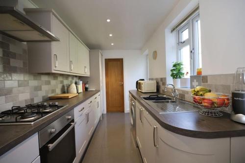 a kitchen with a sink and a counter top at Luxury House Near City Center Hospital &Superstore in Carlisle