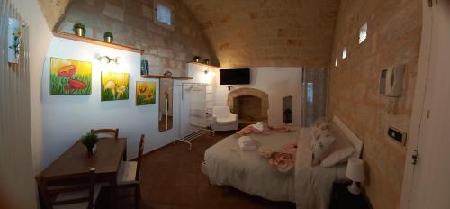 Habitación con cama, mesa y escritorio. en Villino Tronchetto Bianco, en Mola di Bari
