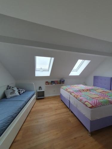 um quarto com 2 camas e 2 clarabóias em Luxusferienhaus am Naherholungsgebiet mit SAUNA em Jägersburg