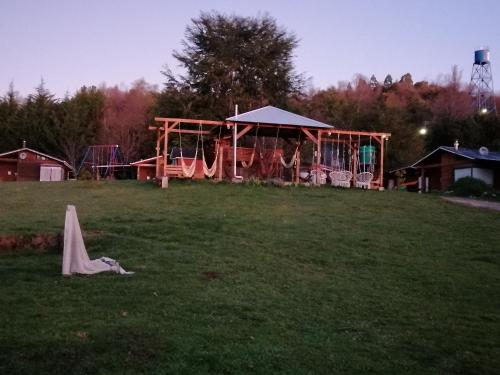 a park with a playground and a play structure at Turismo Jaos Cabañas Tinas y Quincho in Futrono