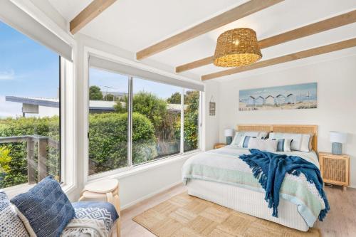 een slaapkamer met een bed en een groot raam bij Bayview Cottage in Ventnor