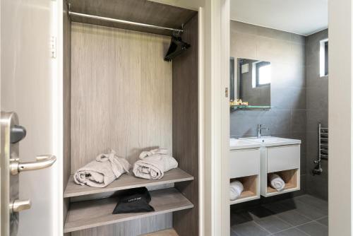 a bathroom with a sink and a toilet and towels at The Roost on Rock Road in Barry