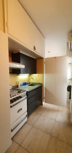 a kitchen with a stove and a white stove top oven at Palermo Panoramic in Buenos Aires
