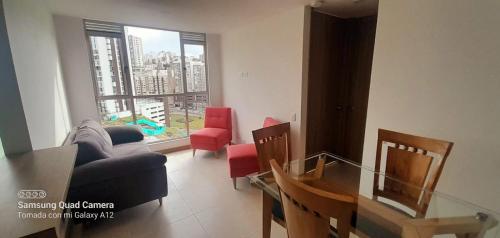 ein Wohnzimmer mit einem Sofa, einem Tisch und Stühlen in der Unterkunft Apartamento Urapanes La Toscana in Manizales