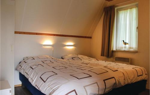 a large bed in a room with a window at 3 Bedroom Beautiful Home In Gramsbergen in Gramsbergen