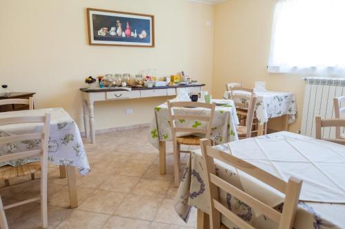 a dining room with tables and chairs and a counter at Dolce Sosta in Lucca