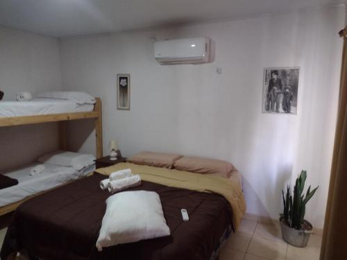 a room with two beds with towels on them at ESPACIO CANELA in Ramallo