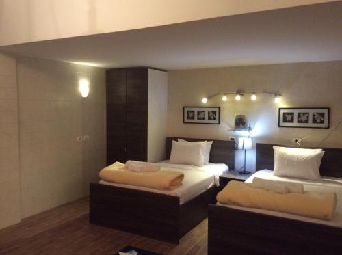 a hotel room with two beds and two lamps at Sakan 275 in Cairo