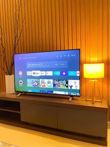 a large flat screen tv sitting on top of a table at Villa Ruby - with private swimming pool in Kota Bharu