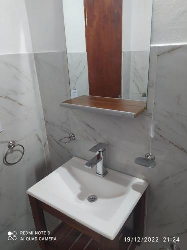 a bathroom with a white sink and a mirror at Departamento Rosales Nro 2 in Valeria del Mar