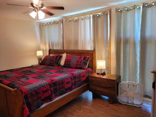 a bedroom with a bed and a ceiling fan at Gram's Place MtnTop 2/2 Cottage on 100 quiet acres 