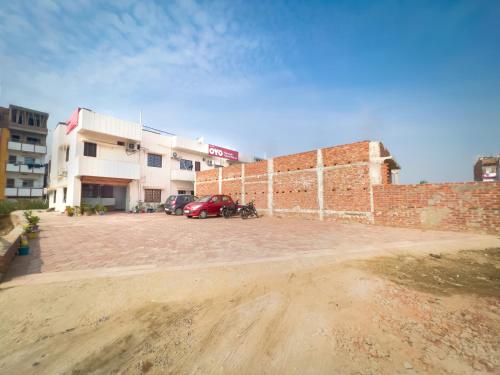 a parking lot in front of a brick building at Hotel Nalanda Guest House in Nalanda