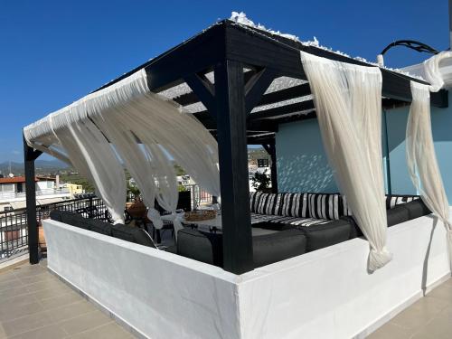 a pergola on the roof of a house at Magical Seaside Town Boutique Apts 2 in Kyparissia