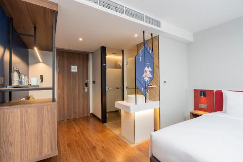 a hotel room with a bed and a bathroom at Centara Life Hotel Bangkok Phra Nakhon in Bangkok