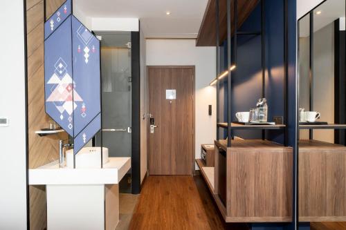 a room with a hallway with a door and a counter at Centara Life Hotel Bangkok Phra Nakhon in Bangkok