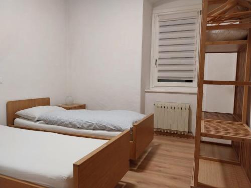 a bedroom with two bunk beds and a window at Appartamento vista Parco Adamello Brenta in Ossana