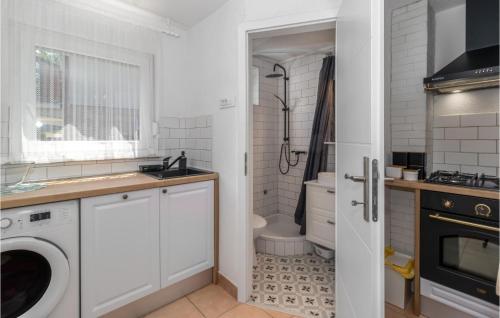 a white bathroom with a sink and a toilet at Beautiful Home In Crikvenica With Kitchen in Crikvenica