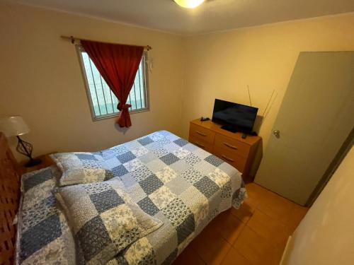 Ένα ή περισσότερα κρεβάτια σε δωμάτιο στο Cabaña Bahía Loreto - Bahia Inglesa