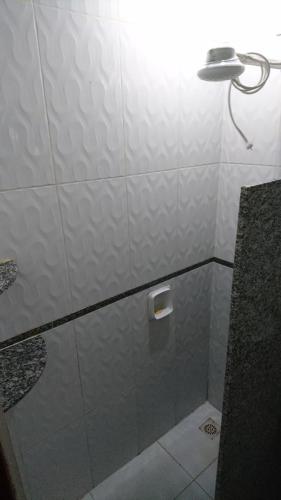 a bathroom with a shower with a light on it at Residencial Silva in Bonito