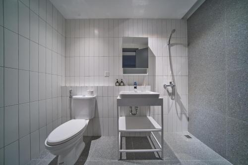 a bathroom with a toilet and a sink at M Village Living Hồ Biểu Chánh in Ho Chi Minh City