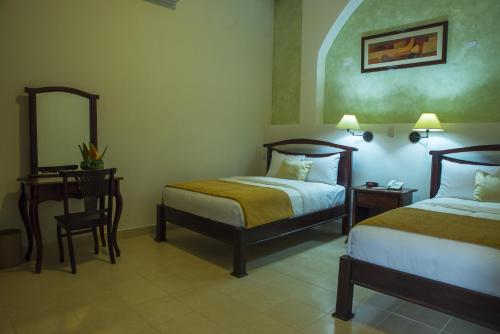 Hotel Real La Mercedにあるベッド