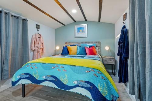 a bedroom with a large bed with a colorful comforter at La Mia Casa in Sarasota
