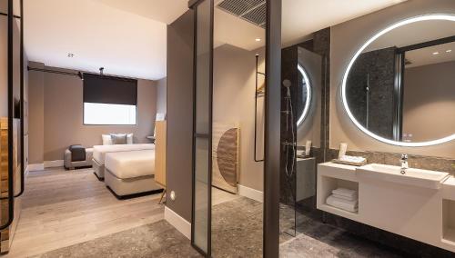a hotel room with a bed and a bathroom at Travelodge Nimman in Chiang Mai