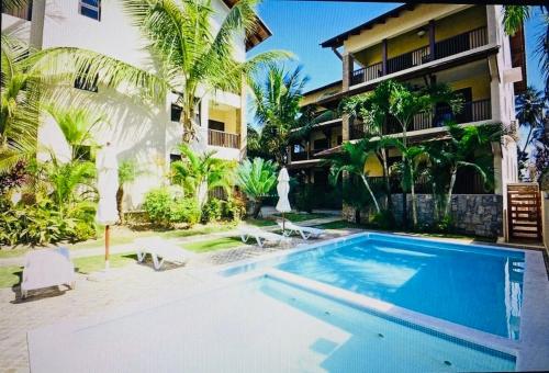 a swimming pool in front of a building at Lovely Beachfront 2 bedrooms condo with 2 pools in Las Terrenas