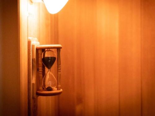 an hourglass is hanging on a wall in a room at Hotel Sunset Terrace in Chatan