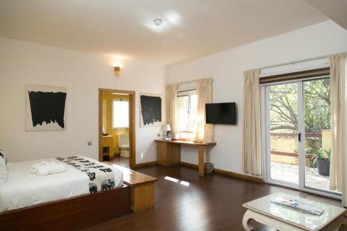 a bedroom with a bed and a large window at Superior Room Space Available in Accra