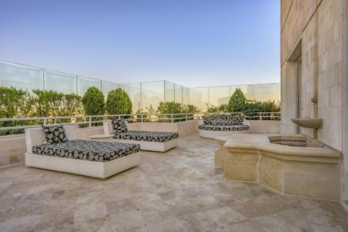 a patio with couches and a fountain on a building at Grand Hyatt Amman in Amman