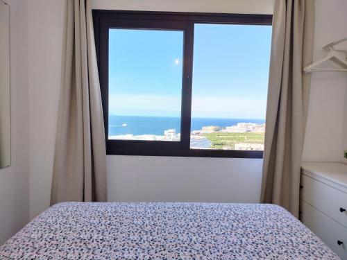 a bedroom with a bed and a view of the ocean at Relax And Sunset in Paraiso Adeje in Adeje