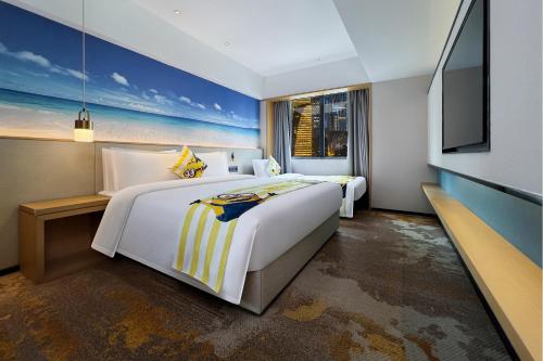 a hotel room with two beds and a flat screen tv at Ausotel Smart Guangzhou Zhujiang New Town, Canton Fair Free Shuttle 15 Oct to 04 Nov in Guangzhou