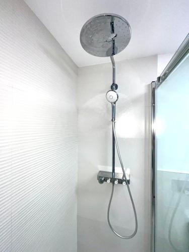 a shower with a shower head in a bathroom at Arena y Calma Jandia con aire acondicionado in Morro del Jable