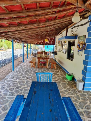 a blue bench on a patio with a table at Aqua Arina Holiday Farm House in Murud