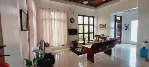 a living room with a chair and a table at Andrew n Sophia's Guest House in Puerto Princesa City