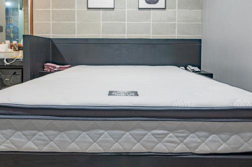 a bed in a room with a mattressvisorvisorvisorvisor at Boutique Hotel XYM in Suwon