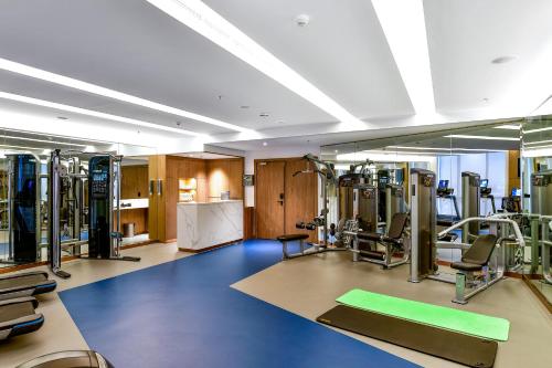 a gym with several treadmills and machines at Clarion Hotel Jeddah Airport in Jeddah