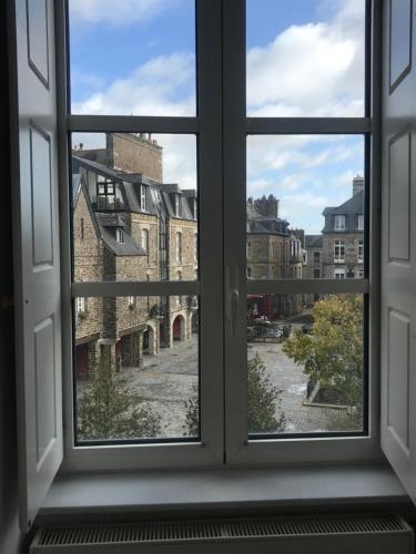 an open window with a view of a city street at Mercier de Montigny - Les Chambres du Beffroi - SPA et Massage in Fougères