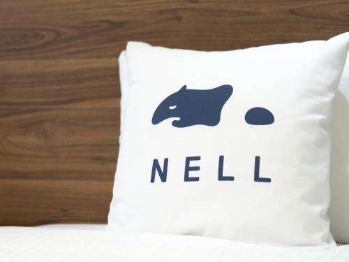 a pillow with the word netil written on it at Tabist Ginza in Tokyo