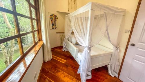 a bedroom with a bed with a canopy at The Treehouse in Nakuru