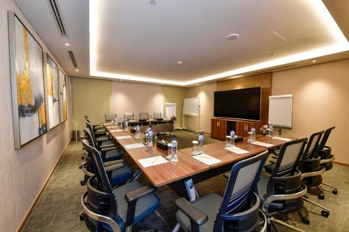 a large conference room with a long table and chairs at Clarion Hotel Jeddah Airport in Jeddah