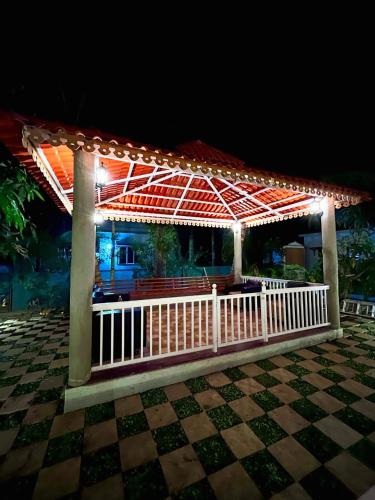 a gazebo with lights on it at night at Sundeck Villa in Alibaug