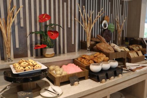 a buffet with different types of food on a table at Dream of Aventus Hotel Kuta in Kuta