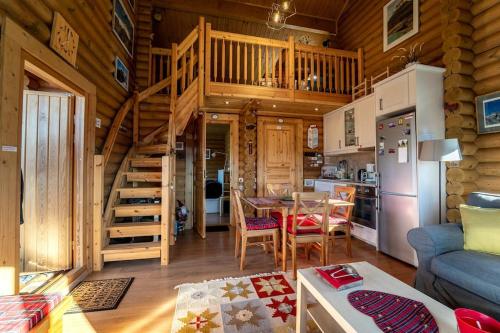 a living room and kitchen with a wooden cabin at The Flysch in Miríki