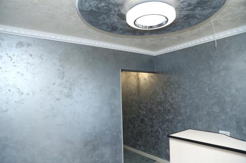 a bathroom with a ceiling with a round light at Hotel MARUNA in Sevan