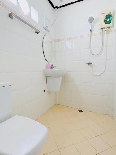 a bathroom with a toilet and a sink and a shower at Baan Karnjana Hotel Samui in Lamai