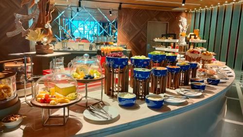 a buffet with blue glasses of food on a table at SUN & MOON, Riverside Hotel in Phnom Penh
