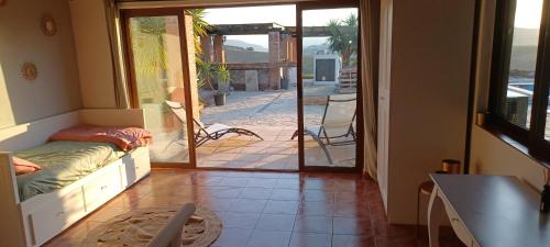 a living room with a door open to a patio at B&B Casa Loré D'or in Alora